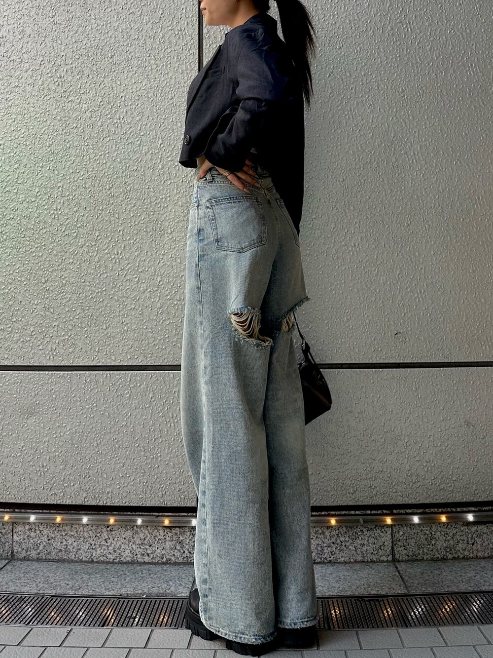 ホワイト系のTシャツ/カットソー、グレー系のテーラードジャケット、ブルー系のデニムパンツを着用したレディースの秋コーディネートの3枚目の写真