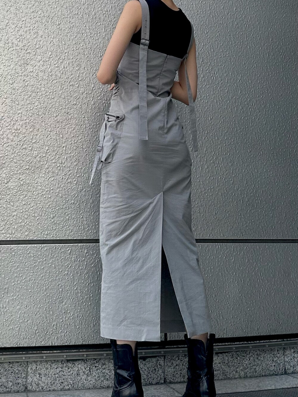 グレー系のワンピース、ブラック系のタンクトップ、ブラック系のブーツを着用したレディースの夏コーディネートの3枚目の写真