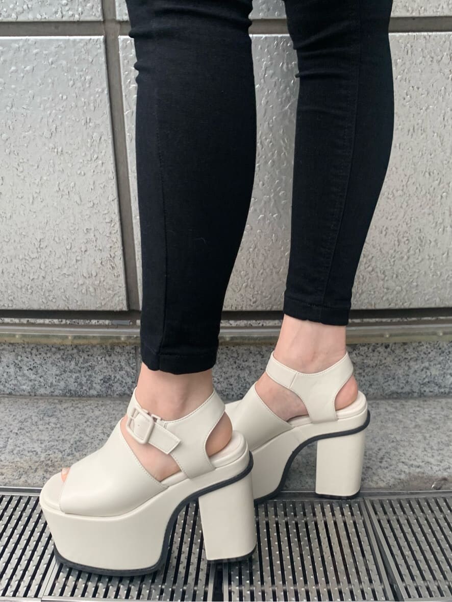 ブラック系のデニムパンツ、ホワイト系のサンダル、ベージュ系のシャツ/ブラウスを着用したレディースの春コーディネートの3枚目の写真