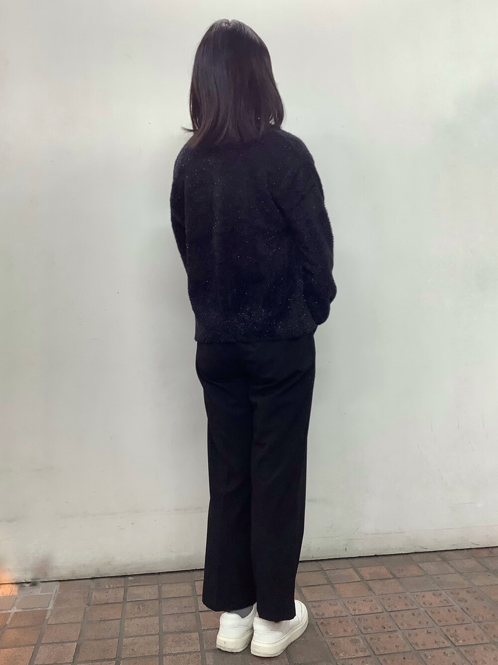 ブラック系のニット/セーターを着用したレディースの冬コーディネートの3枚目の写真