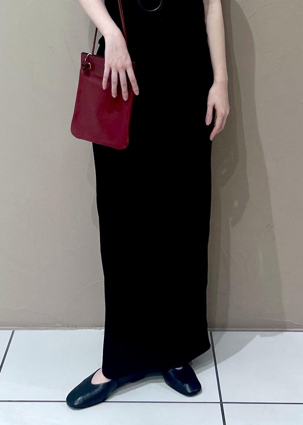 ブラック系のタンクトップ、ブラック系のスカート、ブラック系のパンプスを着用したレディースの夏コーディネートの5枚目の写真