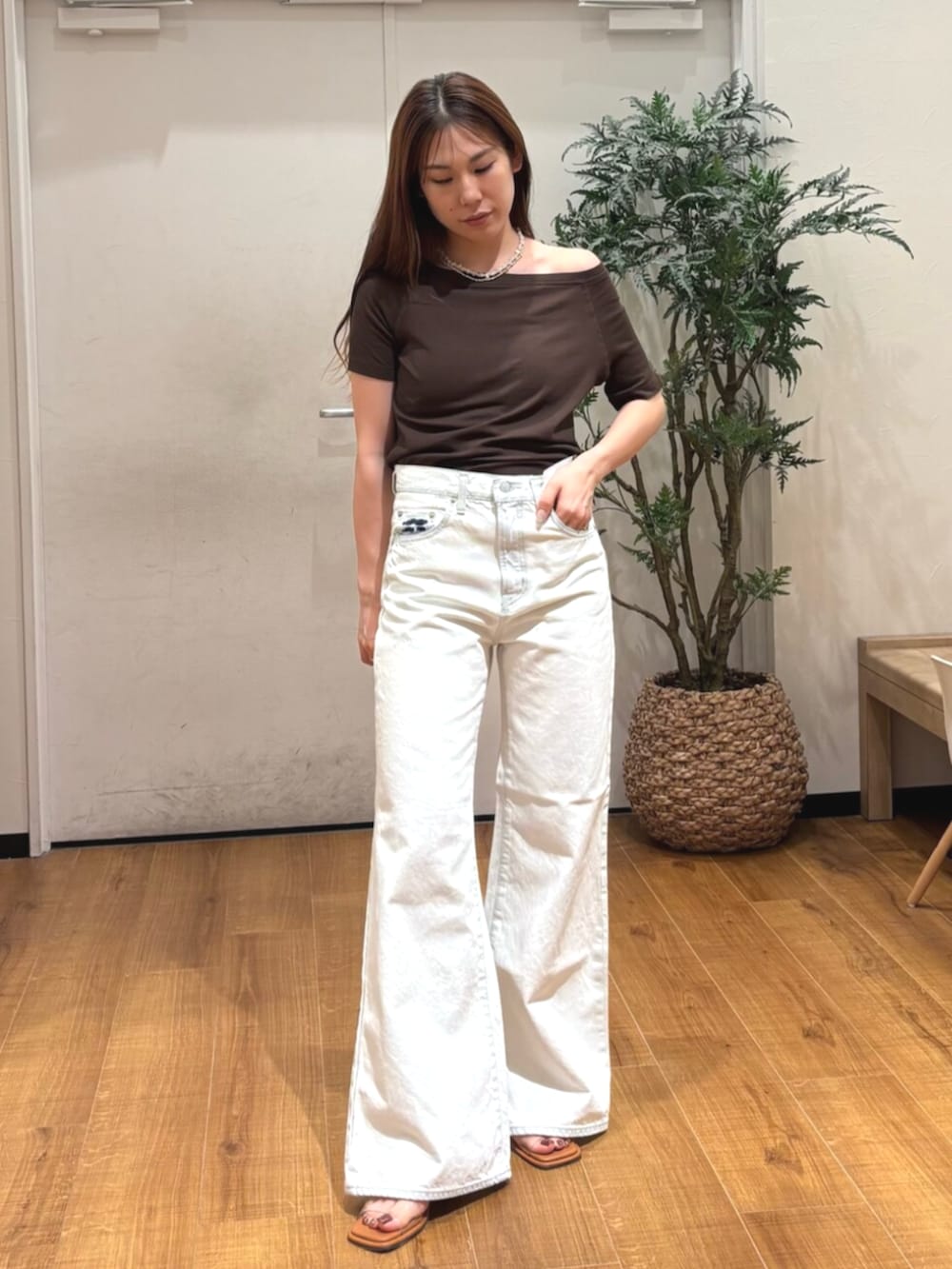 その他のサンダル、ブラウン系のTシャツ/カットソー、ホワイト系のデニムパンツを着用したレディースの春コーディネートの2枚目の写真