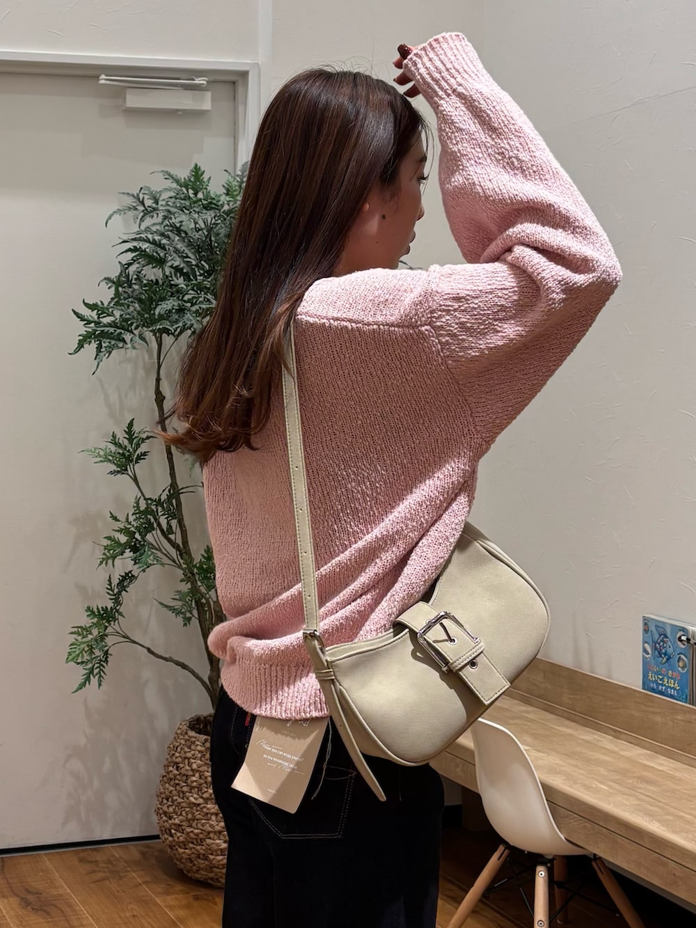 ピンク系のニット/セーター、ブルー系のデニムパンツを着用したレディースの冬コーディネートの6枚目の写真