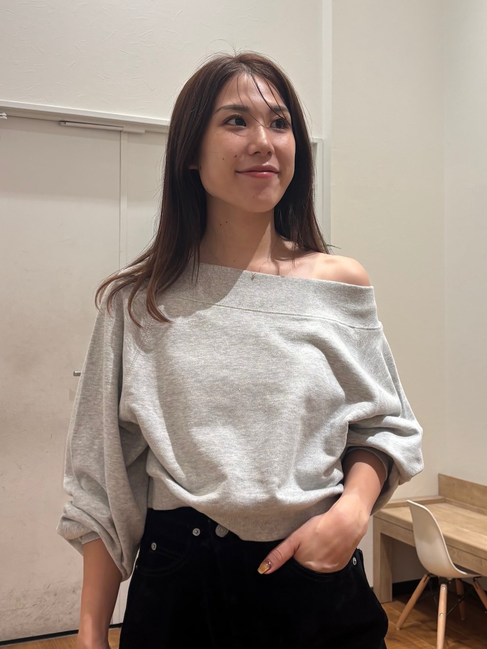 グレー系のスウェット、ブラック系のデニムパンツを着用したレディースの秋コーディネートの5枚目の写真