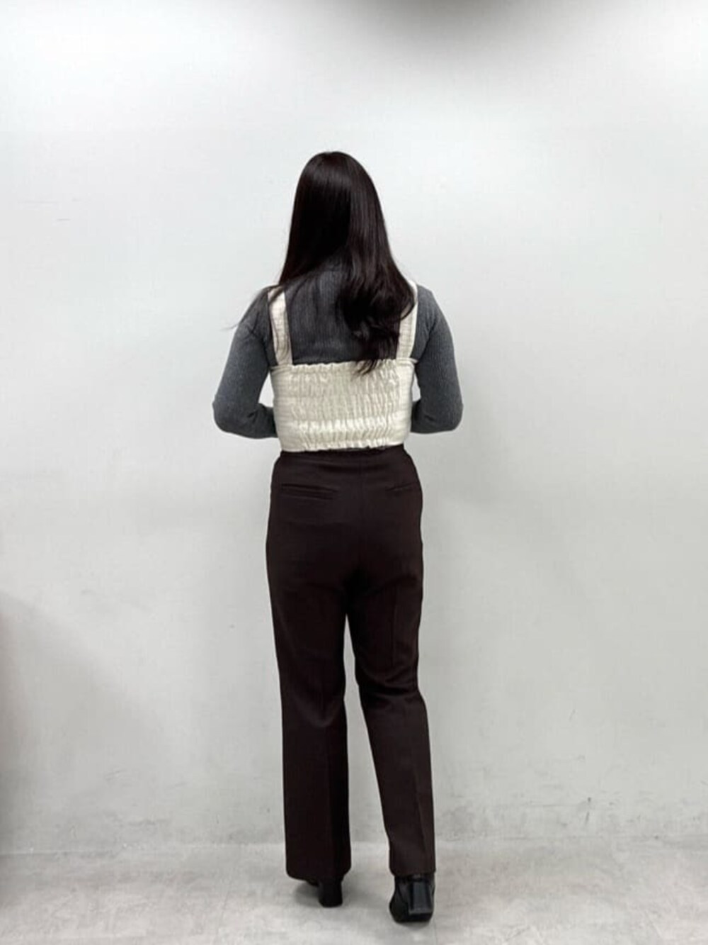 ホワイト系のシャツ/ブラウス、ブラウン系のスラックス、グレー系のニット/セーターを着用したレディースの秋コーディネートの3枚目の写真