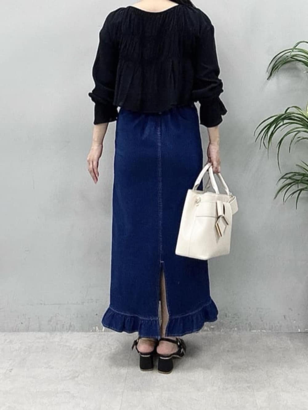 ブルー系のスカート、ブラック系のシャツ/ブラウスを着用したレディースの春コーディネートの3枚目の写真