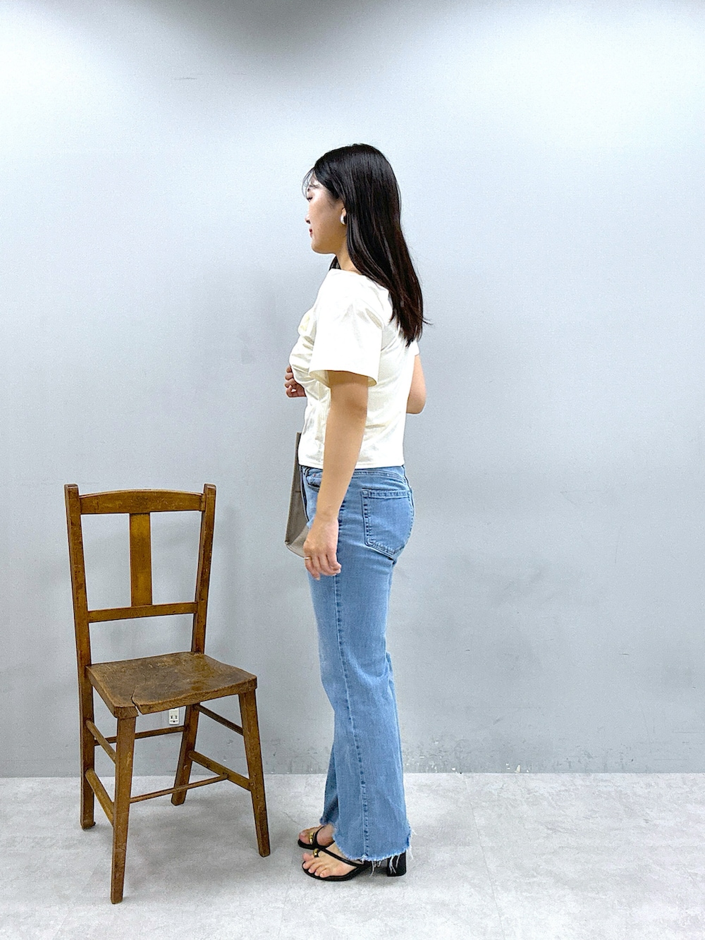 ベージュ系のショルダーバッグ、パープル系のスカート、ホワイト系のTシャツ/カットソーを着用したレディースの春コーディネートの5枚目の写真