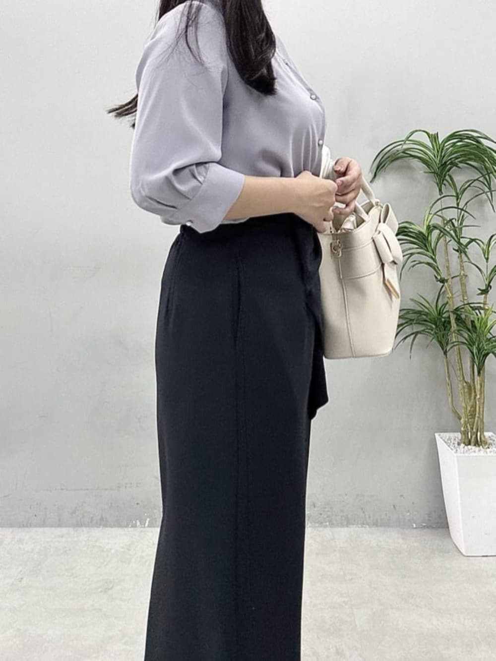 ブラック系のスカート、ホワイト系のカーディガン/ボレロ、ブルー系のシャツ/ブラウスを着用したレディースの春コーディネートの5枚目の写真