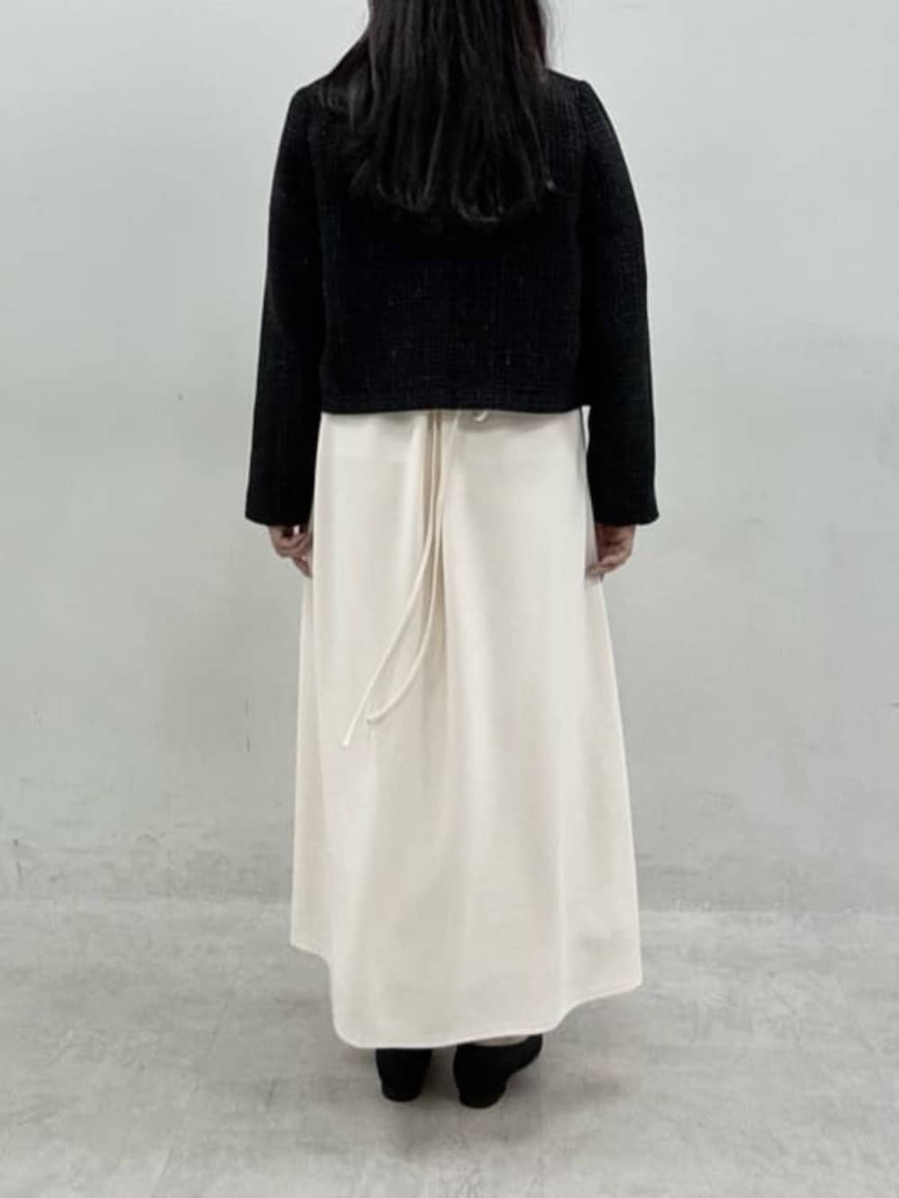 ホワイト系のワンピース、ブラック系のパンプスを着用したレディースの冬コーディネートの3枚目の写真