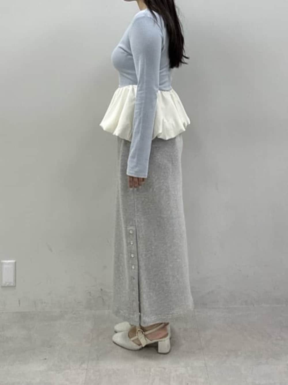 ホワイト系のサンダル、グレー系のスカート、ブルー系のTシャツ/カットソーを着用したレディースの冬コーディネートの2枚目の写真