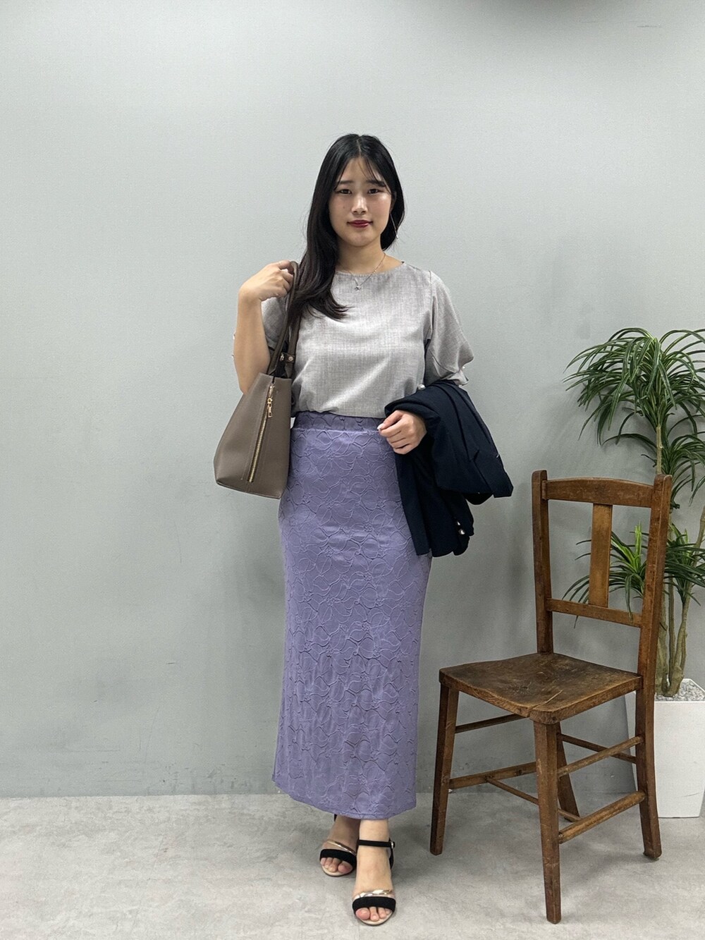 ブラウン系のショルダーバッグ、グレー系のシャツ/ブラウス、ブルー系のその他アウターを着用したレディースの春コーディネートの2枚目の写真