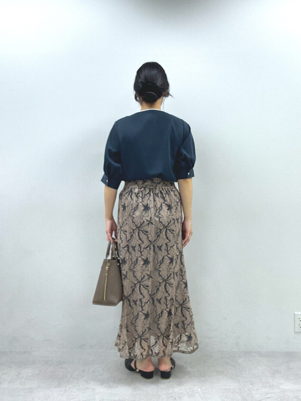 ブルー系のシャツ/ブラウス、ベージュ系のスカートを着用したレディースの春コーディネートの3枚目の写真