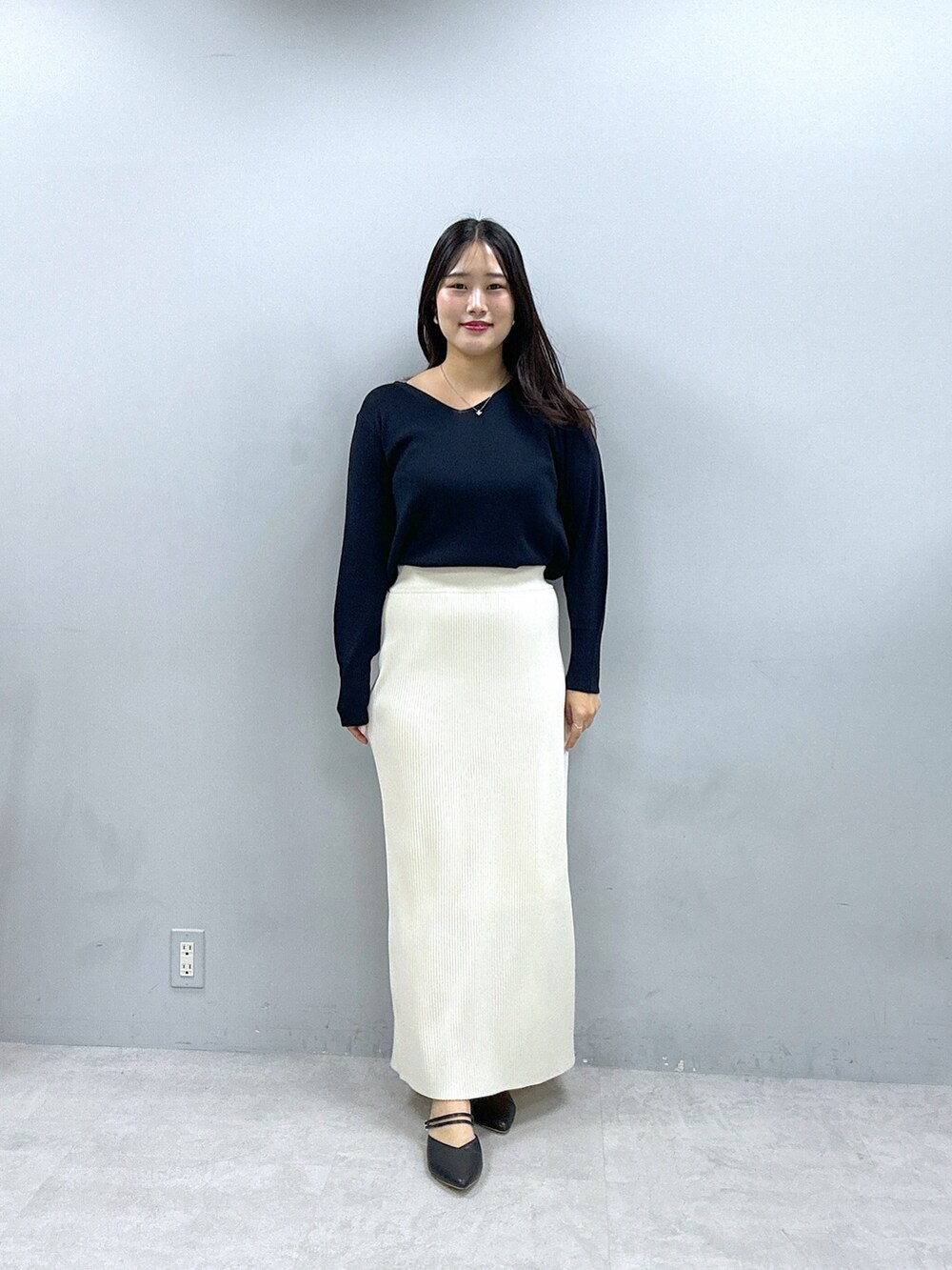 ホワイト系のスカート、ブルー系のニット/セーター、ベージュ系のブルゾンを着用したレディースの春コーディネートの3枚目の写真