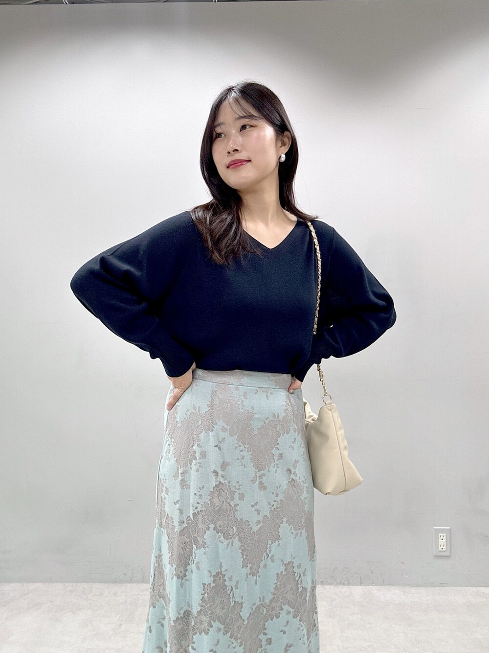 ブルー系のニット/セーター、グリーン系のスカートを着用したレディースの春コーディネートの4枚目の写真