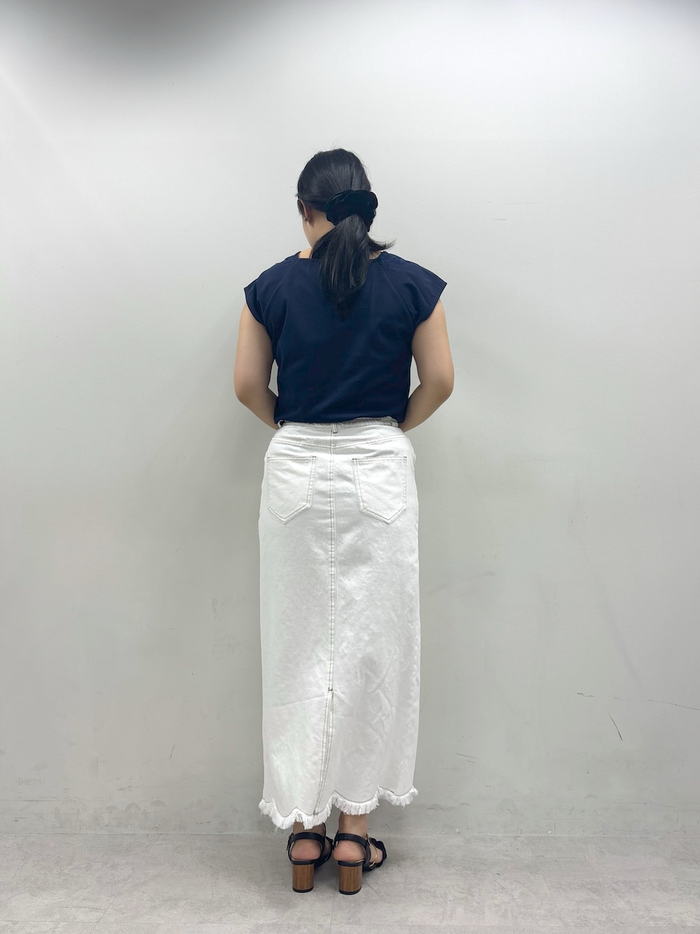ホワイト系のスカート、ブルー系のTシャツ/カットソーを着用したレディースの春コーディネートの3枚目の写真