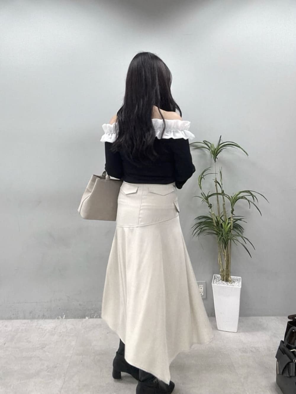 ベージュ系のスカート、ブラック系のTシャツ/カットソーを着用したレディースの夏コーディネートの2枚目の写真
