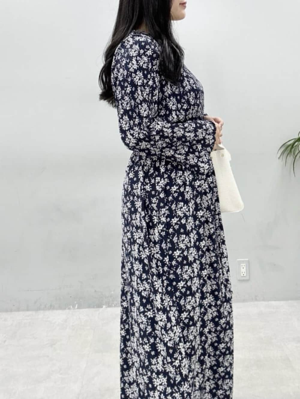 ホワイト系のテーラードジャケット、ホワイト系のハンドバッグ、グレー系のサンダルを着用したレディースの冬コーディネートの8枚目の写真