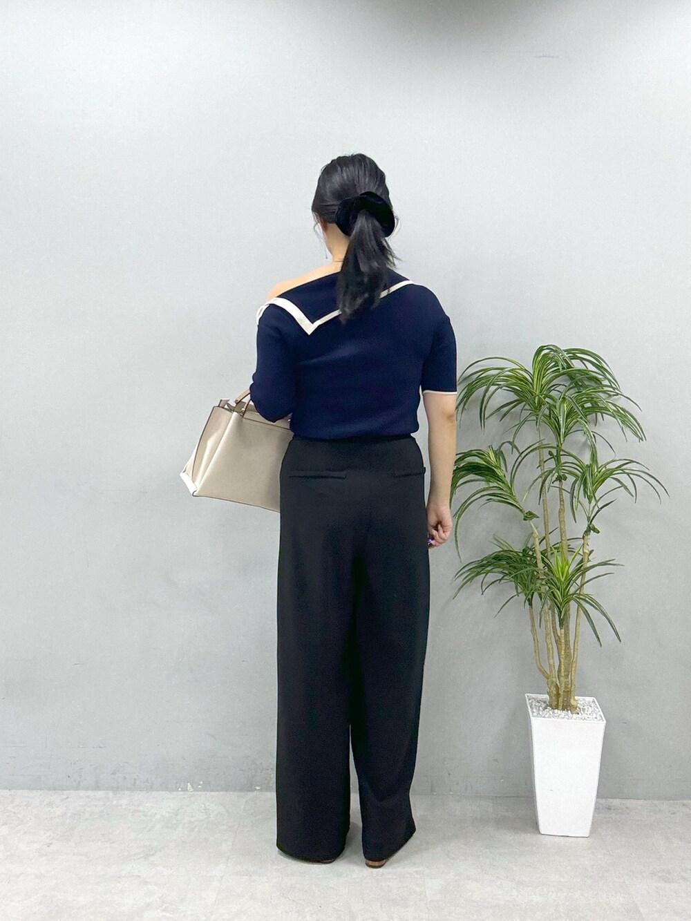 ホワイト系のショルダーバッグ、ブルー系のニット/セーター、ブラック系のその他パンツを着用したレディースの春コーディネートの3枚目の写真