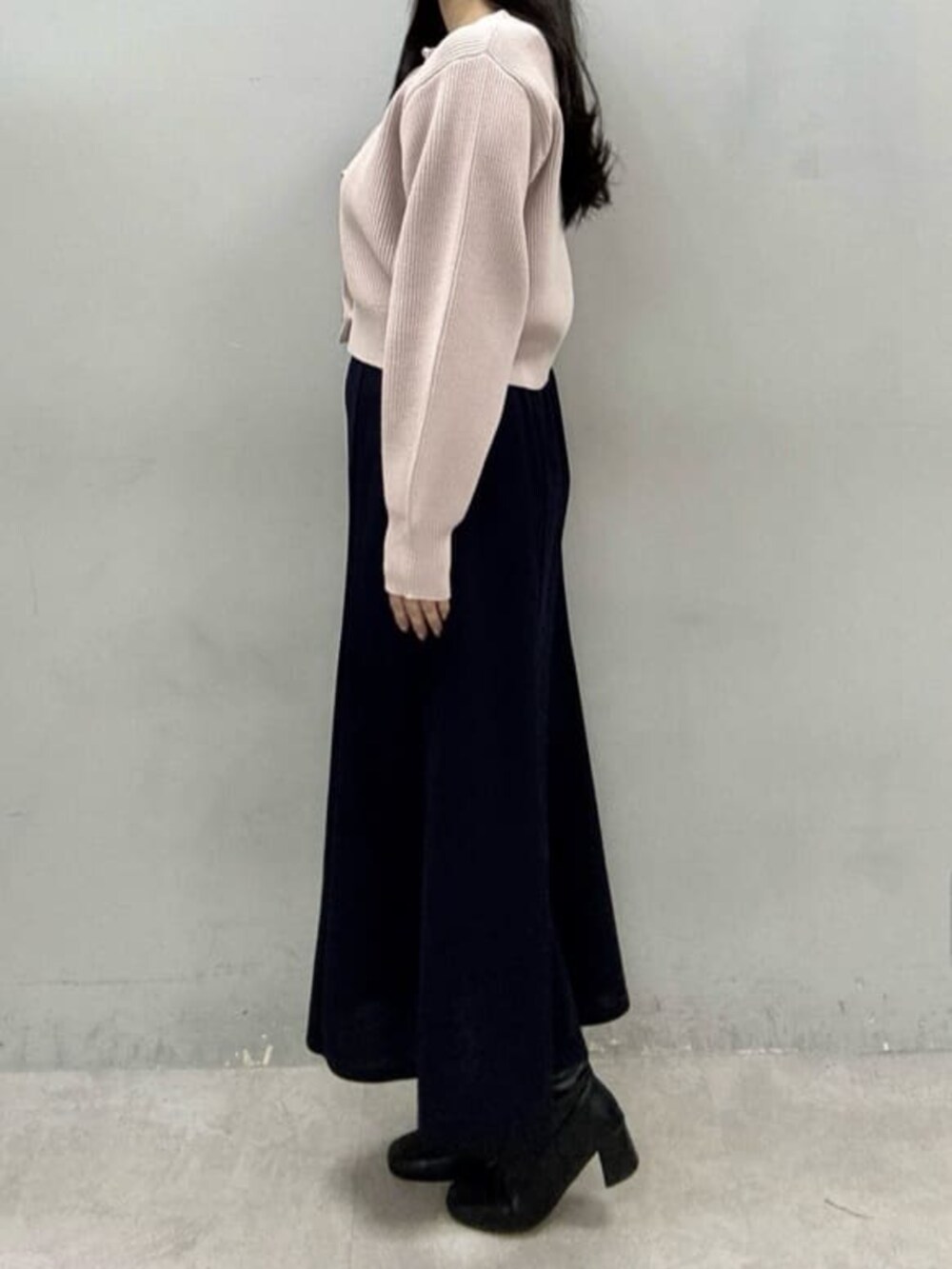 ブルー系のスカート、ピンク系のカーディガン/ボレロを着用したレディースの冬コーディネートの2枚目の写真