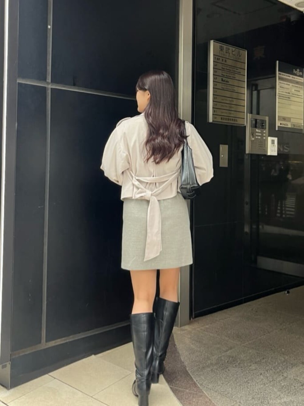 ブルー系のTシャツ/カットソー、グレー系のスカート、ホワイト系のワンピースを着用したレディースの冬コーディネートの2枚目の写真