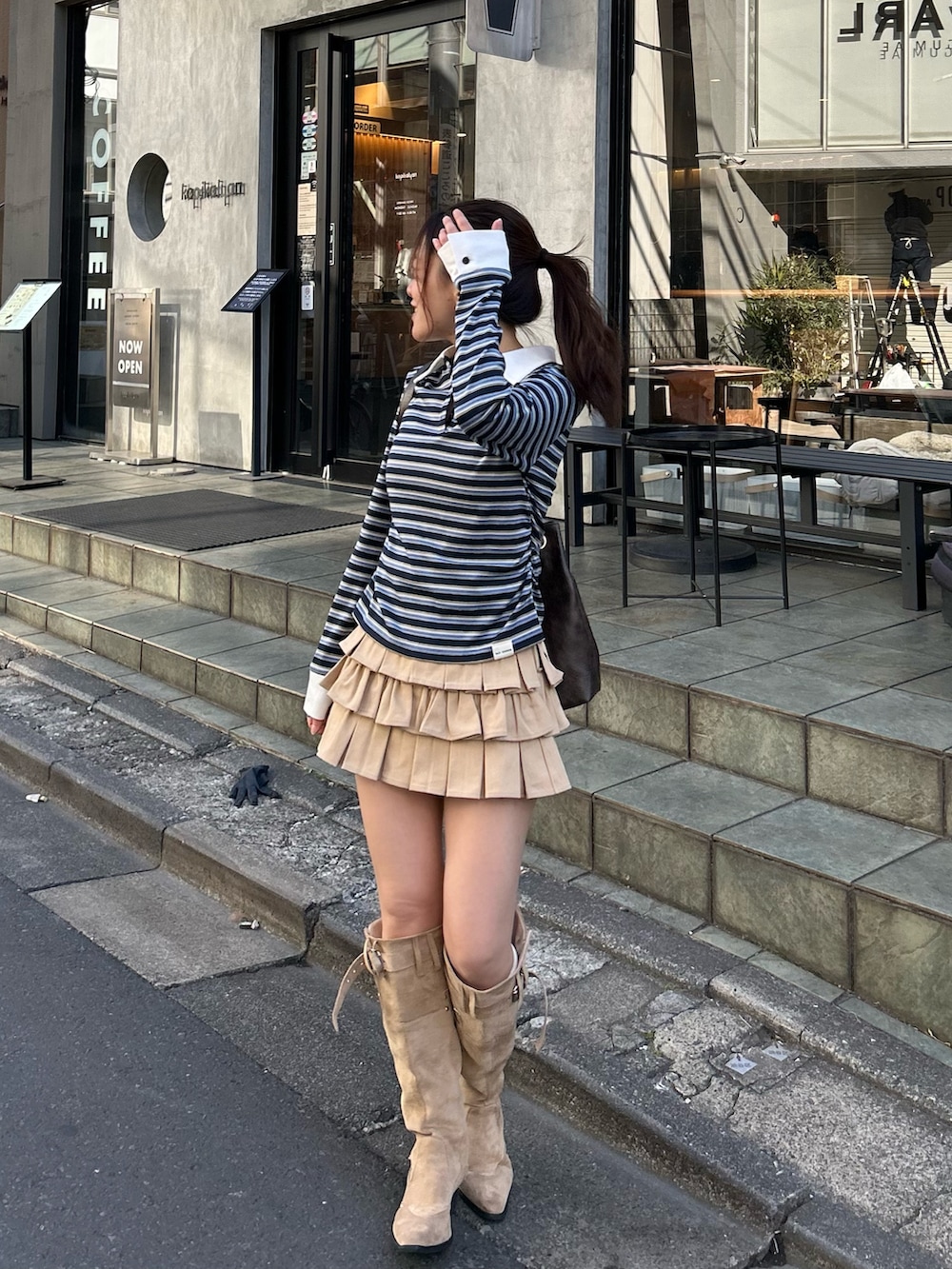 ベージュ系のブルゾン、ブルー系のTシャツ/カットソー、ベージュ系のスカートを着用したレディースの冬コーディネートの5枚目の写真