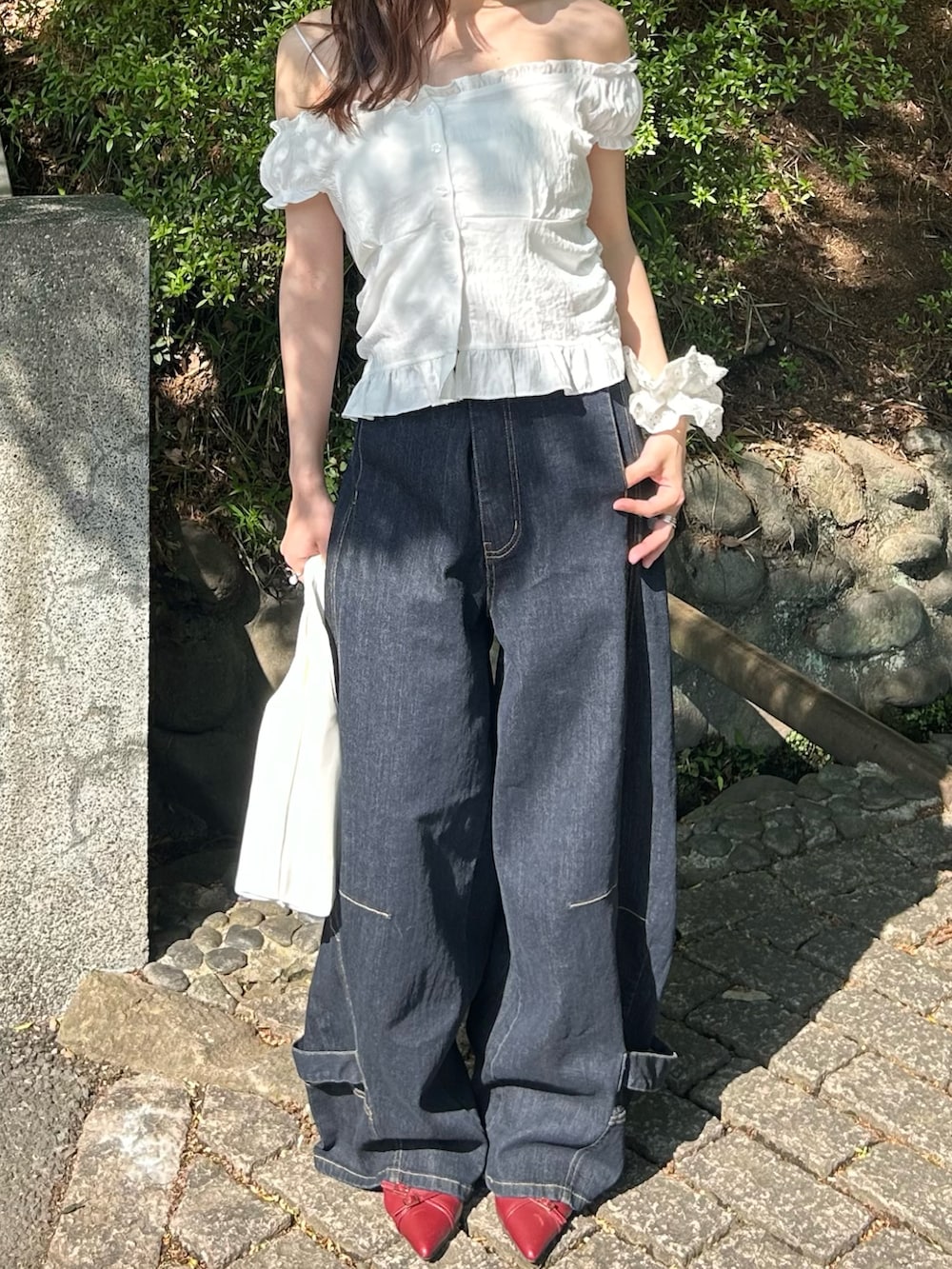 ホワイト系のシャツ/ブラウス、ブルー系のデニムパンツを着用したレディースの春コーディネートの3枚目の写真