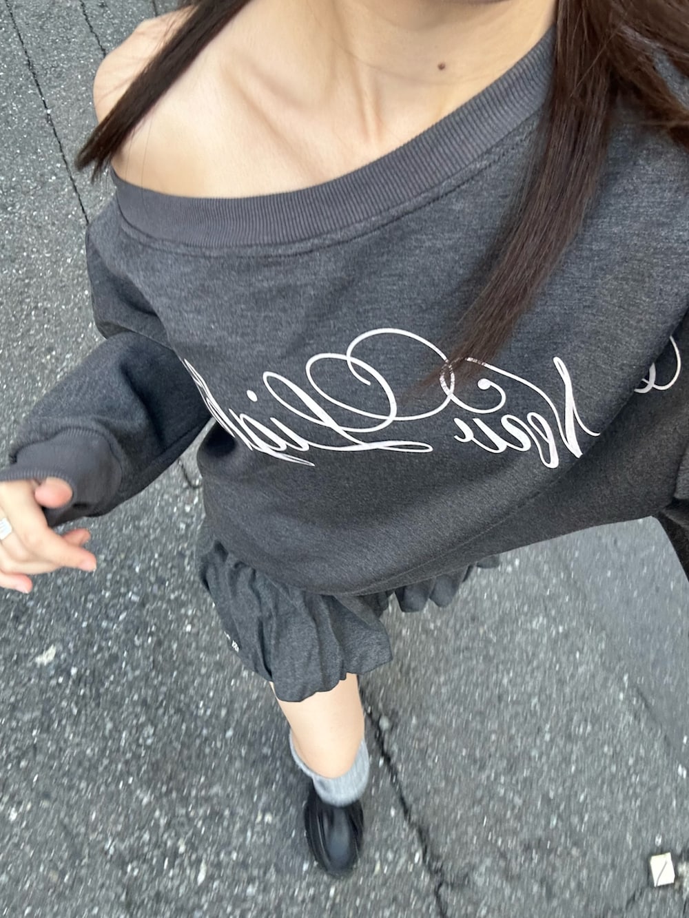 グレー系のスウェット、グレー系のスカート、ブラック系のローファーを着用したレディースの秋コーディネートの4枚目の写真