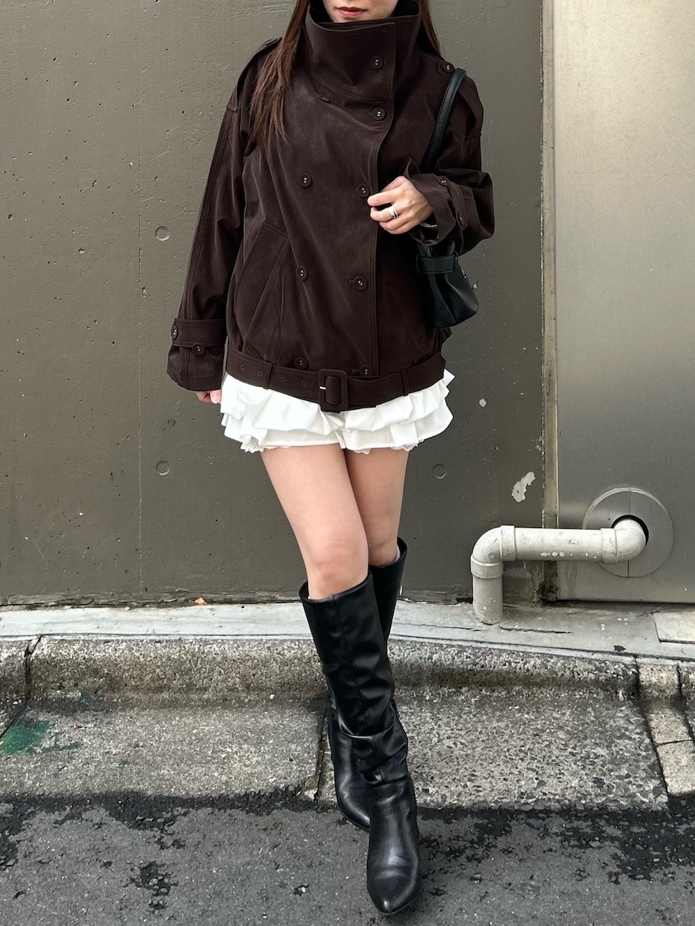 ブラウン系のトレンチコートを着用したレディースの春コーディネートの3枚目の写真