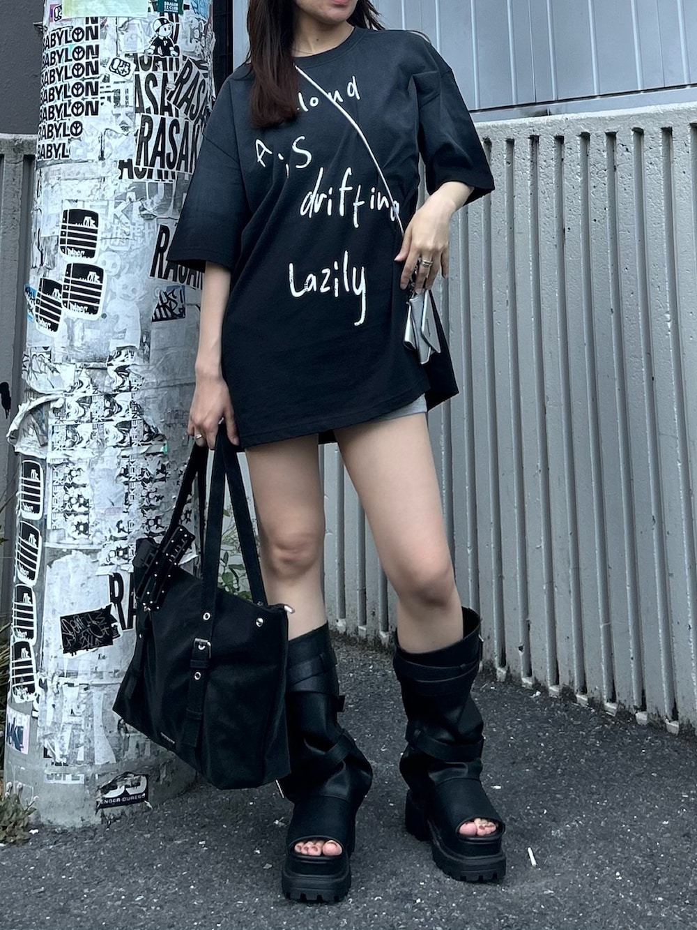 ブラック系のTシャツ/カットソー、ブラック系のサンダル、グレー系のその他パンツを着用したレディースの春コーディネートの7枚目の写真