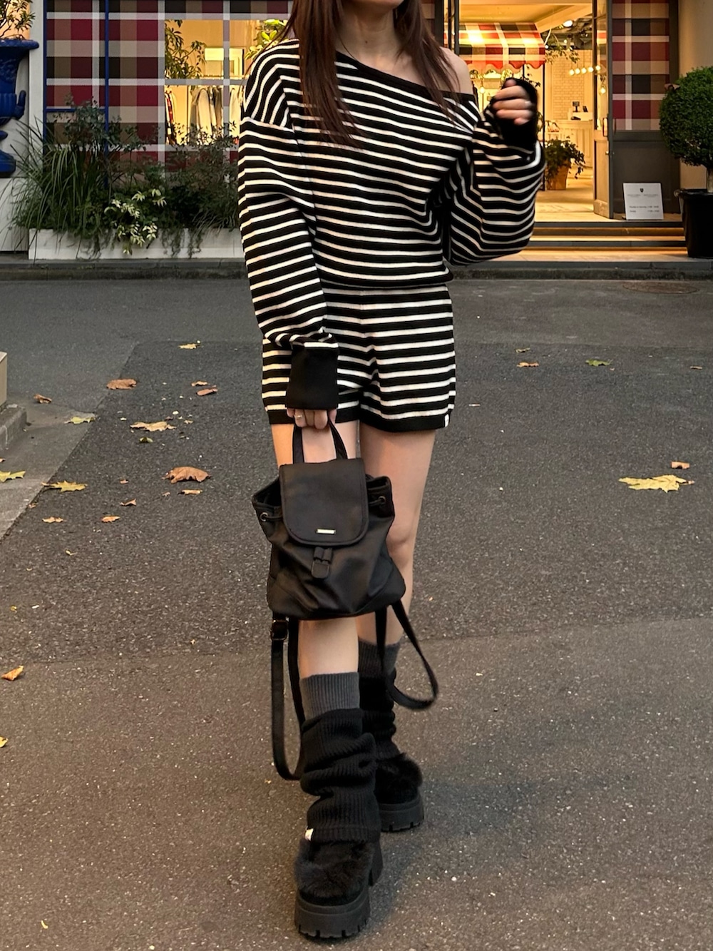 ブラック系のニット/セーター、ブラック系のその他パンツ、ブラック系のバックパック/リュックを着用したレディースの秋コーディネートの6枚目の写真