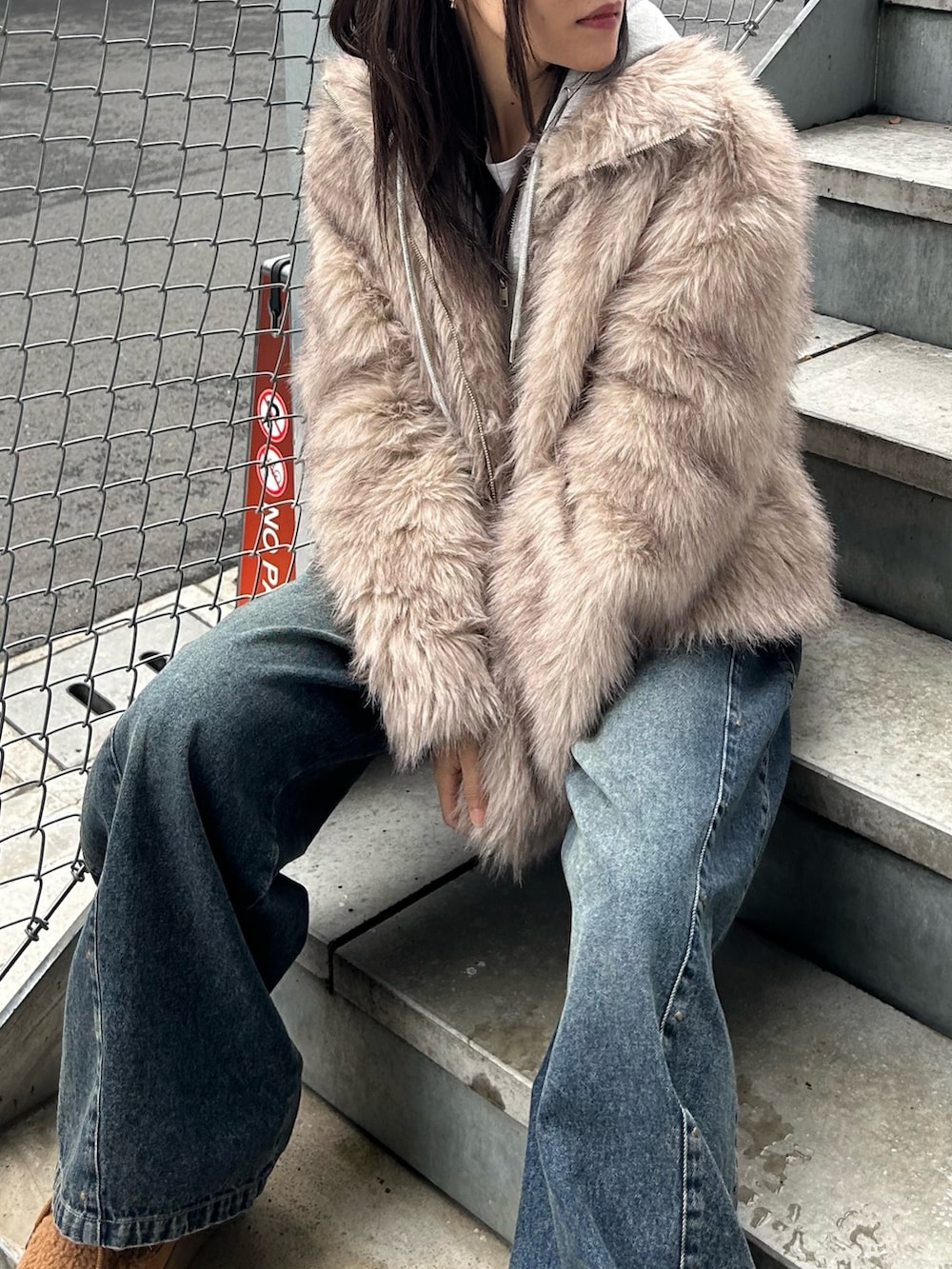 ブルー系のデニムパンツ、ブラック系のトートバッグ、イエロー系のブーツを着用したレディースの秋コーディネートの5枚目の写真