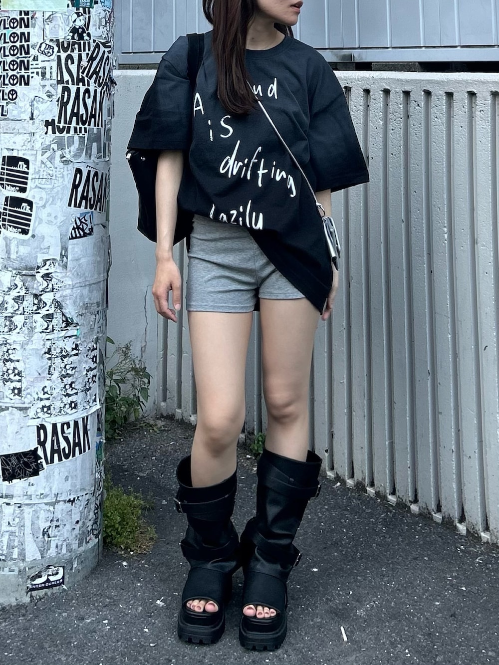 ブラック系のTシャツ/カットソー、ブラック系のサンダル、グレー系のその他パンツを着用したレディースの春コーディネートの5枚目の写真