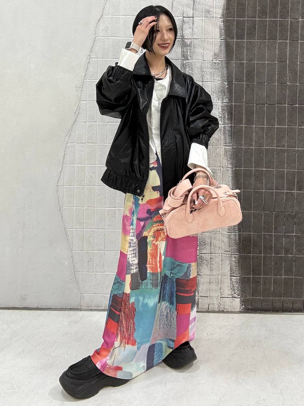 ブラック系のローファー、ピンク系のボストンバッグ、ブラック系のブルゾンを着用したレディースの春コーディネートの3枚目の写真