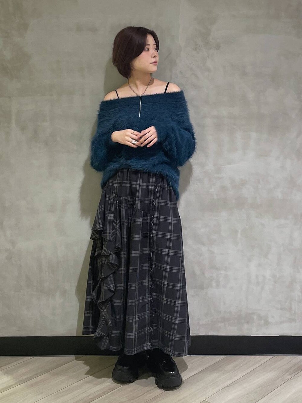 ホワイト系のブーツ、ブルー系のニット/セーター、ブラック系のスカートを着用したレディースの秋コーディネートの5枚目の写真