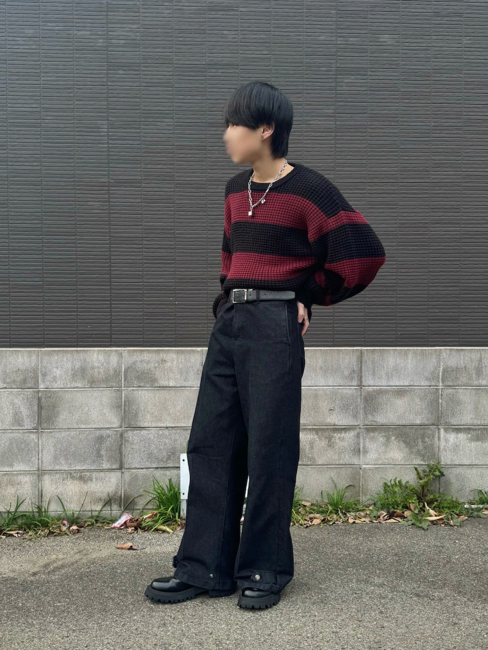 レッド系のニット/セーター、ブラック系のその他パンツ、ブラック系のブーツを着用したメンズの春コーディネートの2枚目の写真