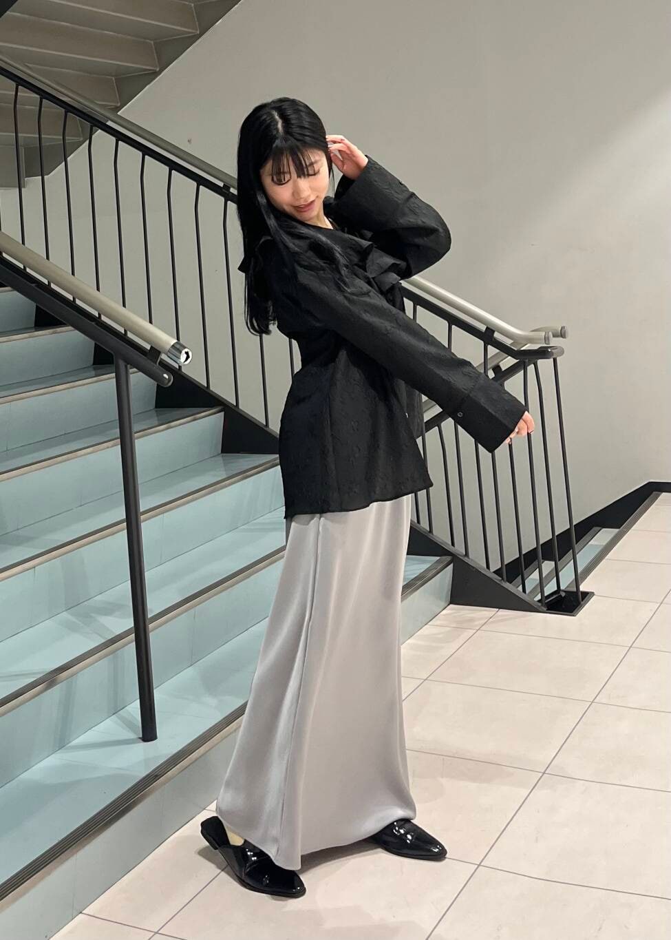 ブラック系のシャツ/ブラウス、グレー系のスカートを着用したレディースの春コーディネートの3枚目の写真