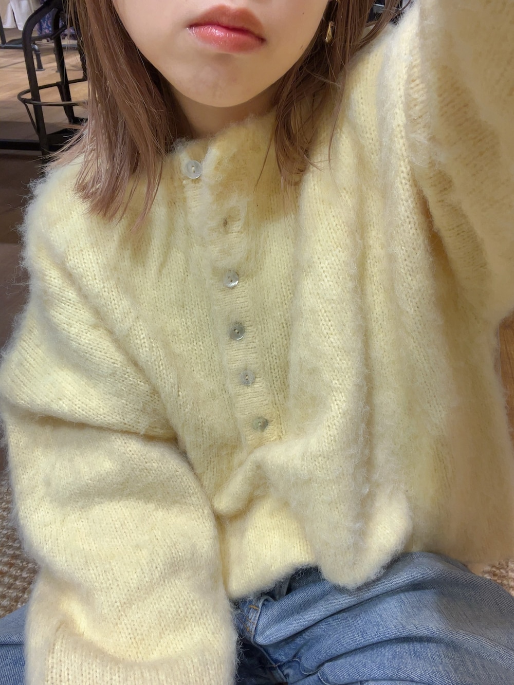 ブルー系のデニムパンツ、イエロー系のニット/セーターを着用したレディースの冬コーディネートの2枚目の写真