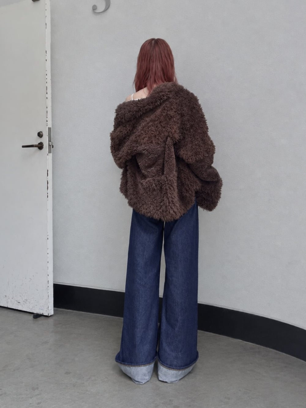 ホワイト系のTシャツ/カットソー、ブルー系のデニムパンツ、ブラウン系のブルゾンを着用したレディースの秋コーディネートの3枚目の写真