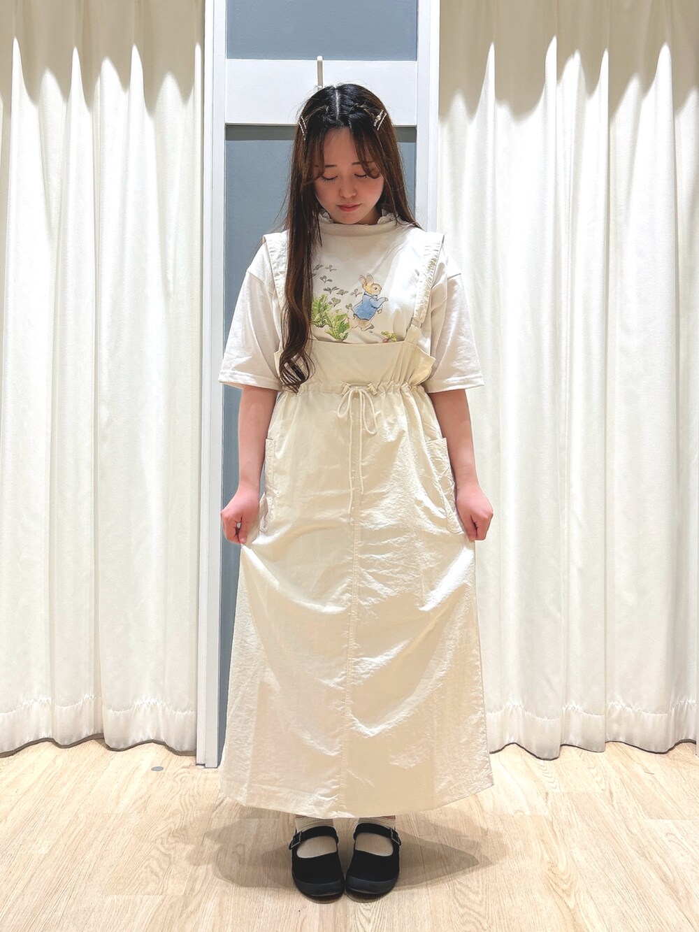 ホワイト系のスカート、ホワイト系のTシャツ/カットソー、ホワイト系のハンドバッグを着用したレディースの夏コーディネートの2枚目の写真