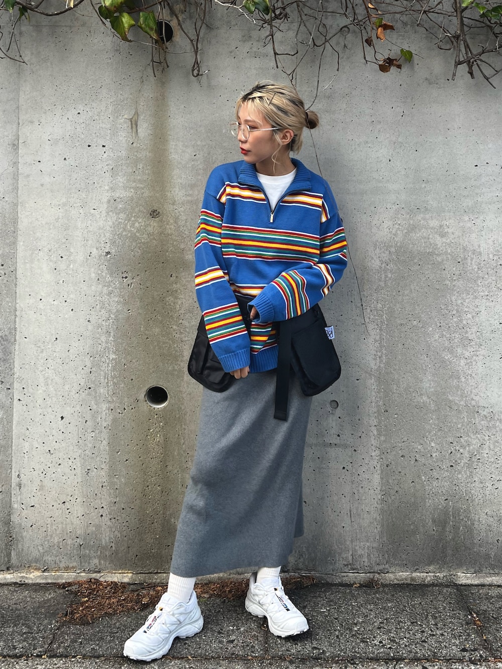 ブルー系のニット/セーター、グレー系のスカート、ブラック系のボディバッグ/ウエストポーチを着用したレディースの冬コーディネートの4枚目の写真