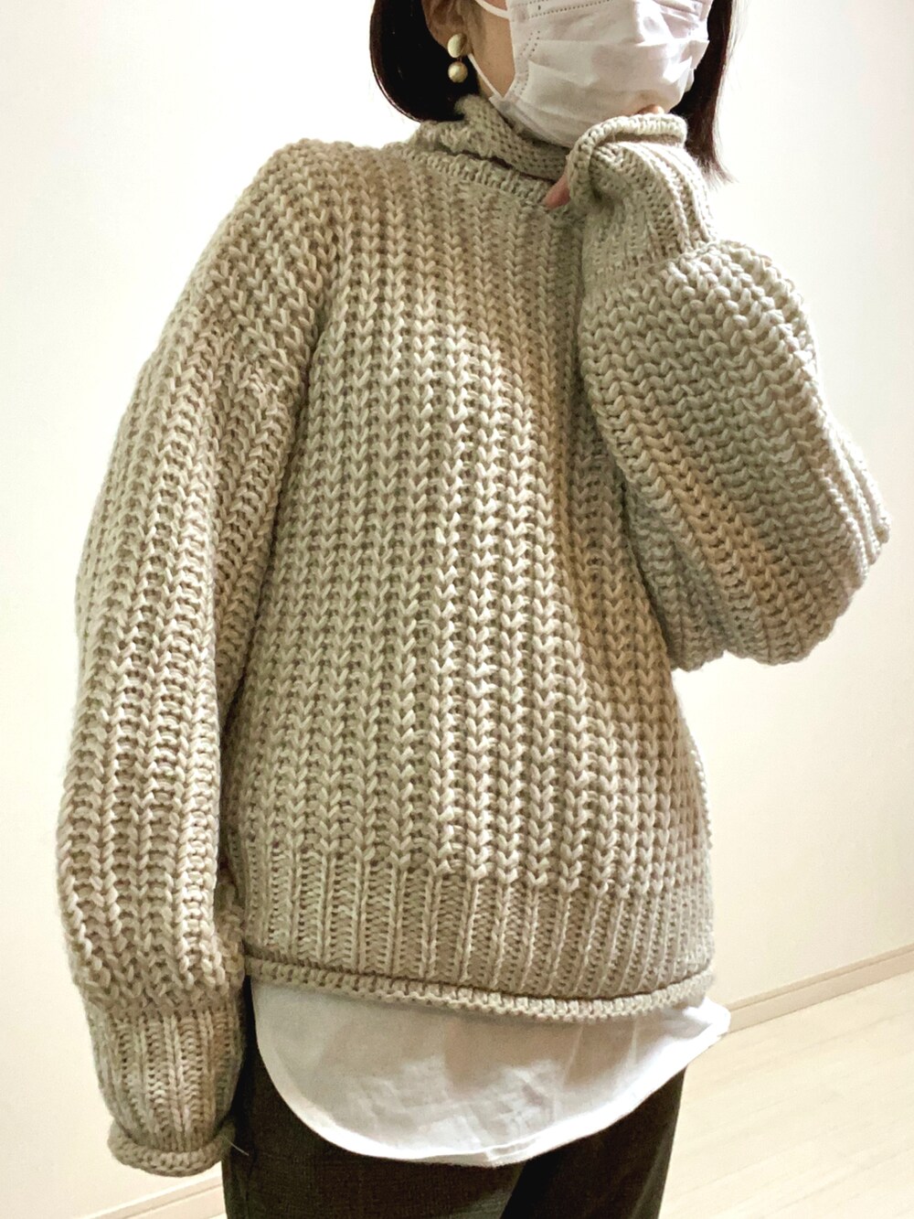 グリーン系のスラックス、ブラック系のスニーカー、ホワイト系のTシャツ/カットソーを着用したレディースの秋コーディネートの2枚目の写真