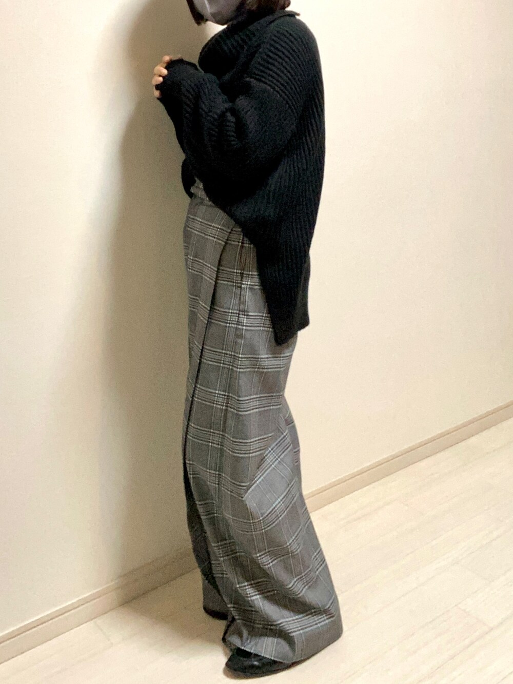 ブラック系のニット/セーター、グレー系のスラックス、ブラック系のローファーを着用したレディースの冬コーディネートの2枚目の写真