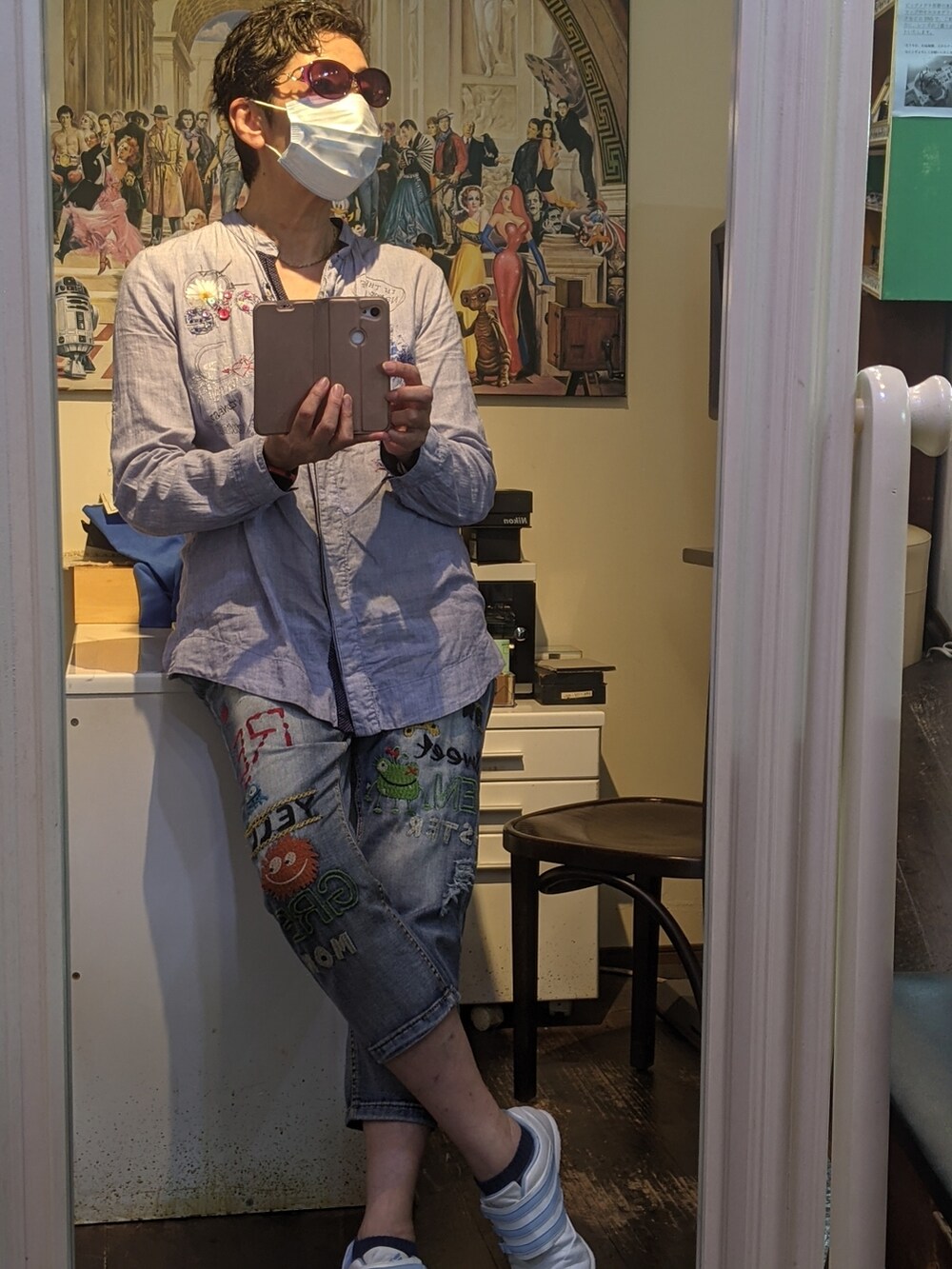 ブルー系のシャツ/ブラウス、ブルー系のデニムパンツ、ホワイト系のスニーカーを着用したレディースの夏コーディネートの3枚目の写真