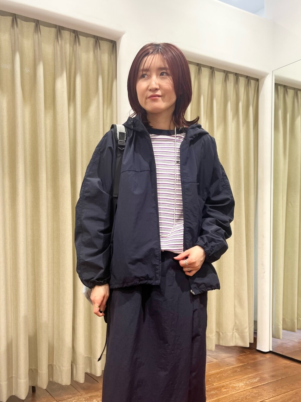 ブルー系のナイロンジャケット、ブルー系のスカート、パープル系のTシャツ/カットソーを着用したレディースの冬コーディネートの4枚目の写真