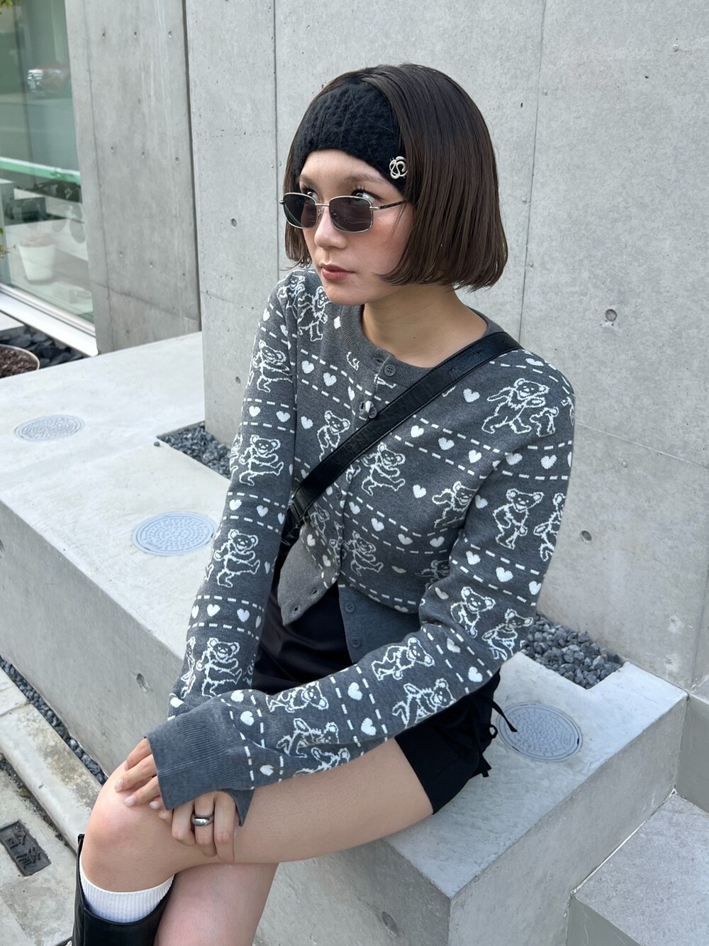 ブラック系のブーツ、グレー系のカーディガン/ボレロ、ブラック系のヘアバンドを着用したレディースの秋コーディネートの2枚目の写真