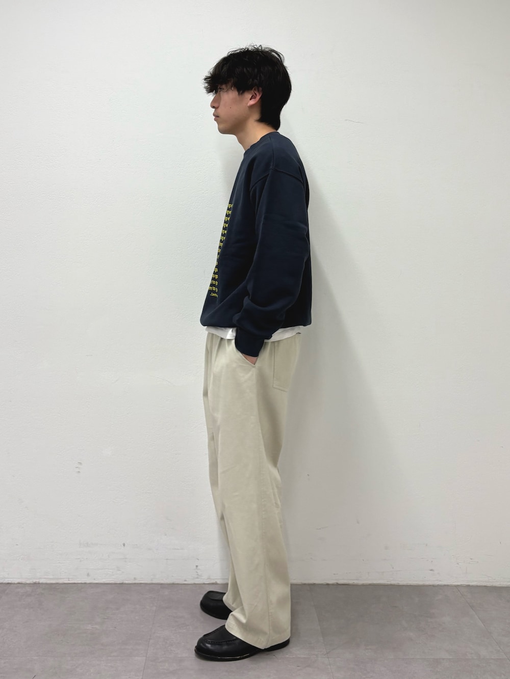 イエロー系のスウェット、ホワイト系のチノパンツを着用したメンズの冬コーディネートの2枚目の写真