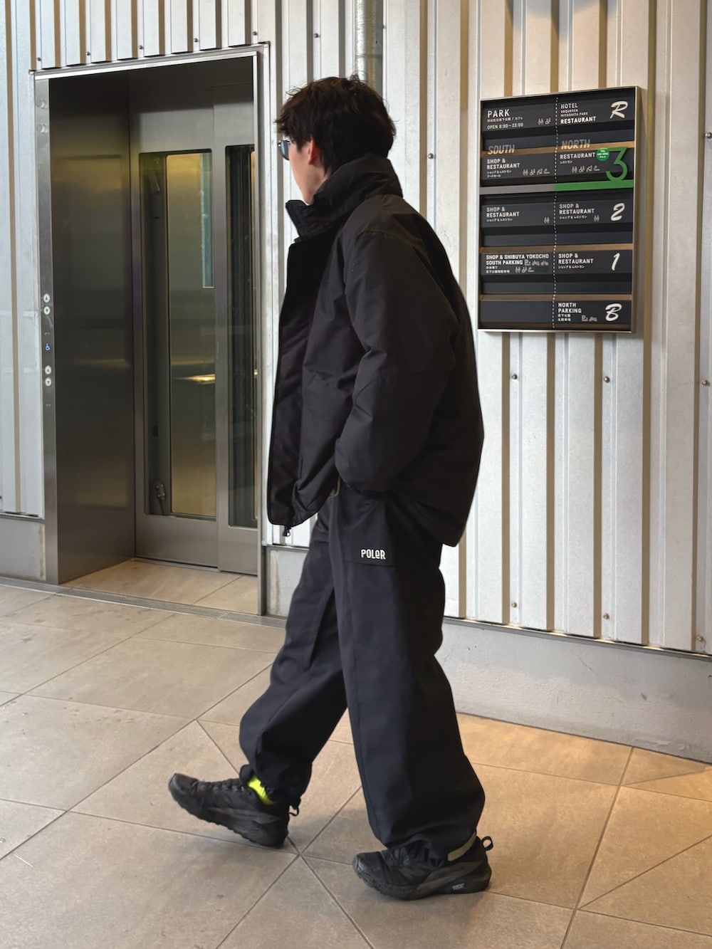 ブラック系のダウンジャケット/コート、ベージュ系のナイロンジャケットを着用したメンズの冬コーディネートの2枚目の写真