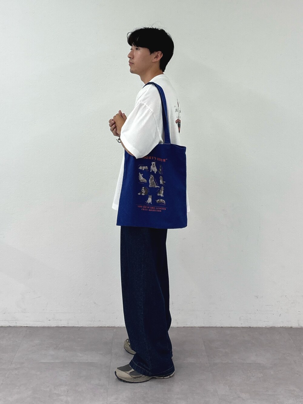 ホワイト系のTシャツ/カットソー、ブルー系のトートバッグ、ブルー系のデニムパンツを着用したメンズの夏コーディネートの2枚目の写真