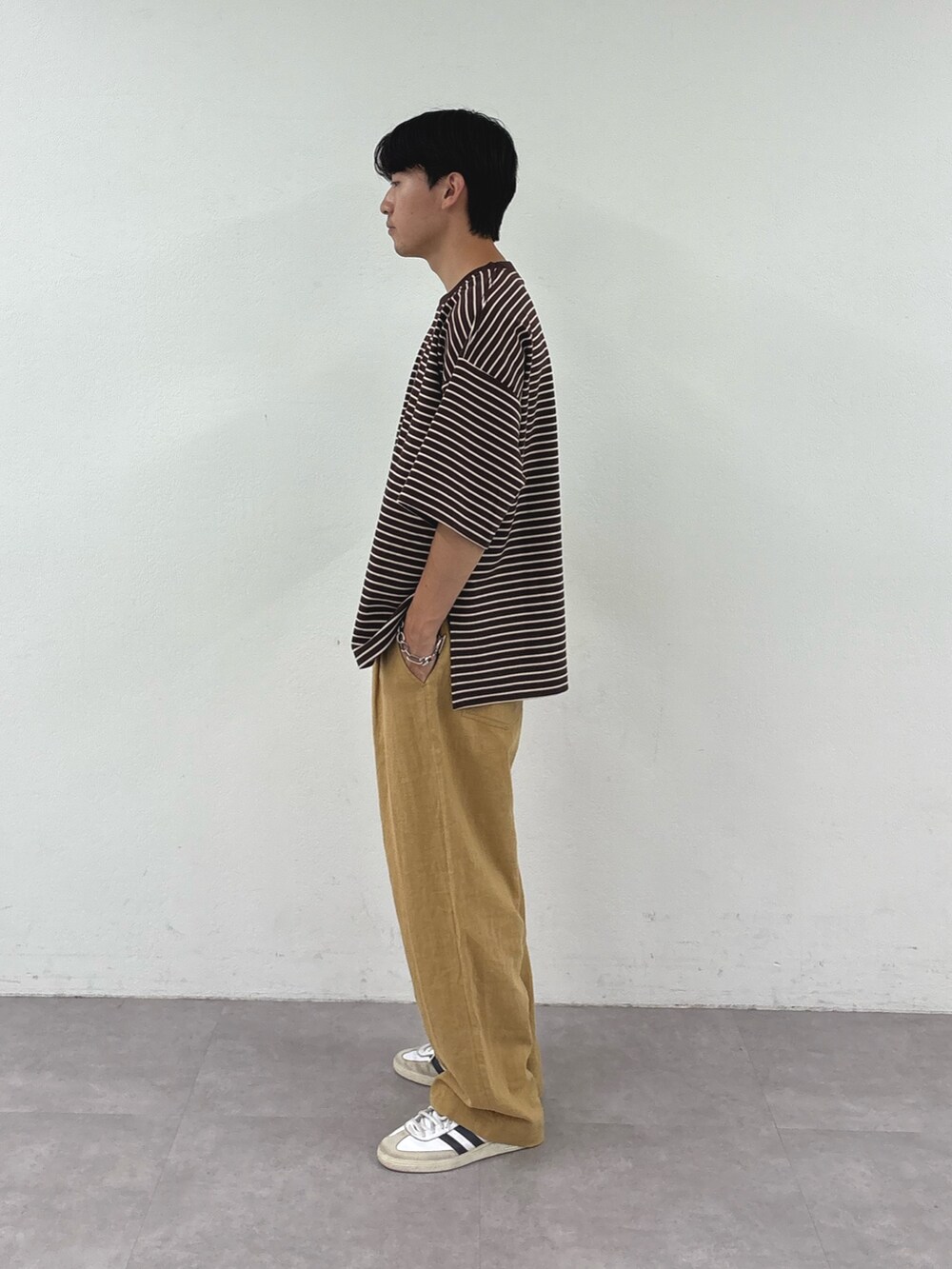 ブラウン系のTシャツ/カットソー、ベージュ系のチノパンツを着用したメンズの夏コーディネートの2枚目の写真