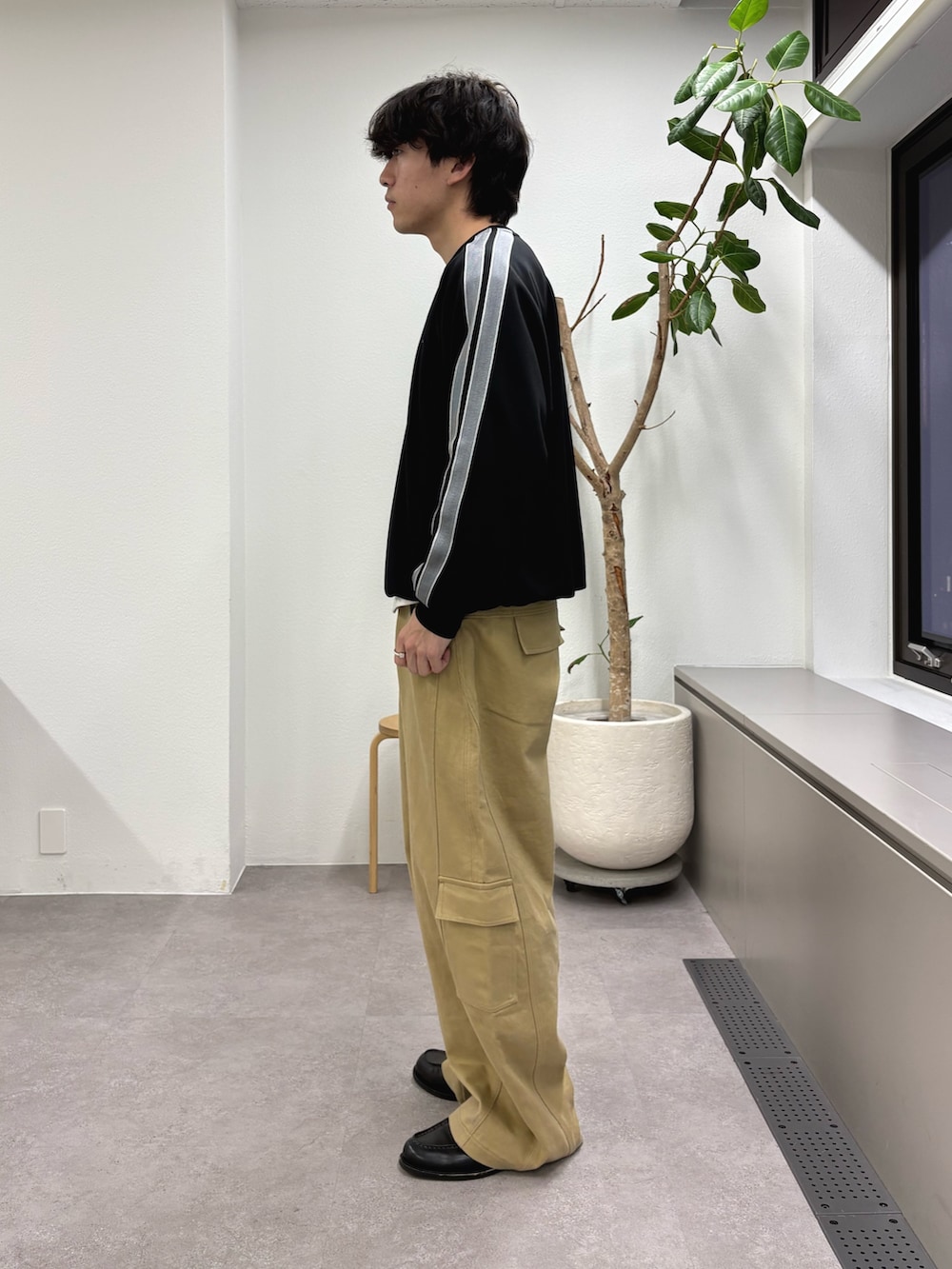 ブラック系のスウェット、ベージュ系のカーゴパンツを着用したメンズの冬コーディネートの2枚目の写真